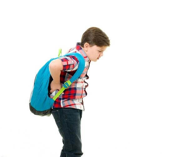 A child dressed in a plaid shirt and jeans carrying a blue backpack over one shoulder, standing against a white background.