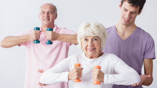 Three individuals of varying ages are exercising with dumbbells, promoting fitness and wellness in a bright, neutral setting.