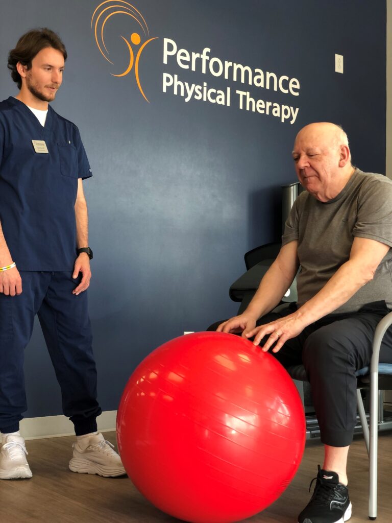 a therapist and an old man in Performance Physical Therapy clinic